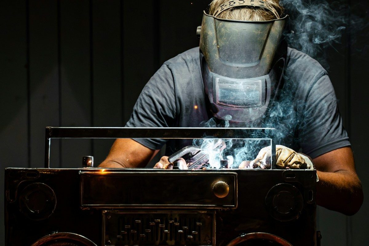 A man in a gas mask working on a radio