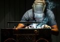 A man in a gas mask working on a radio
